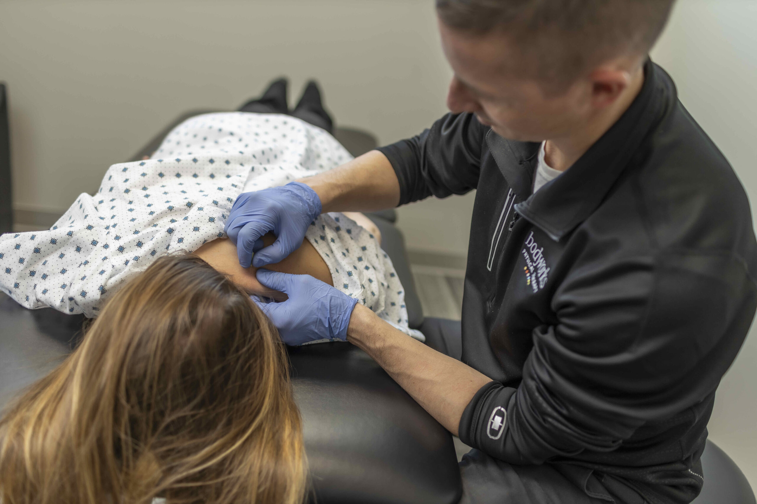 Drew Dry Needling Physical Therapy doing a dry needling technique on a patient's neck