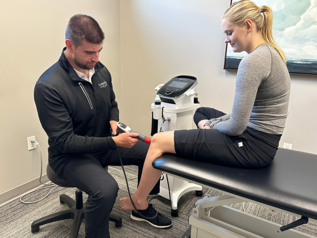 Shockwave Therapy for Knee Pain Physical Therapist at Bodyworks Physical Therapy using shockwave therapy on knee in Fargo ND