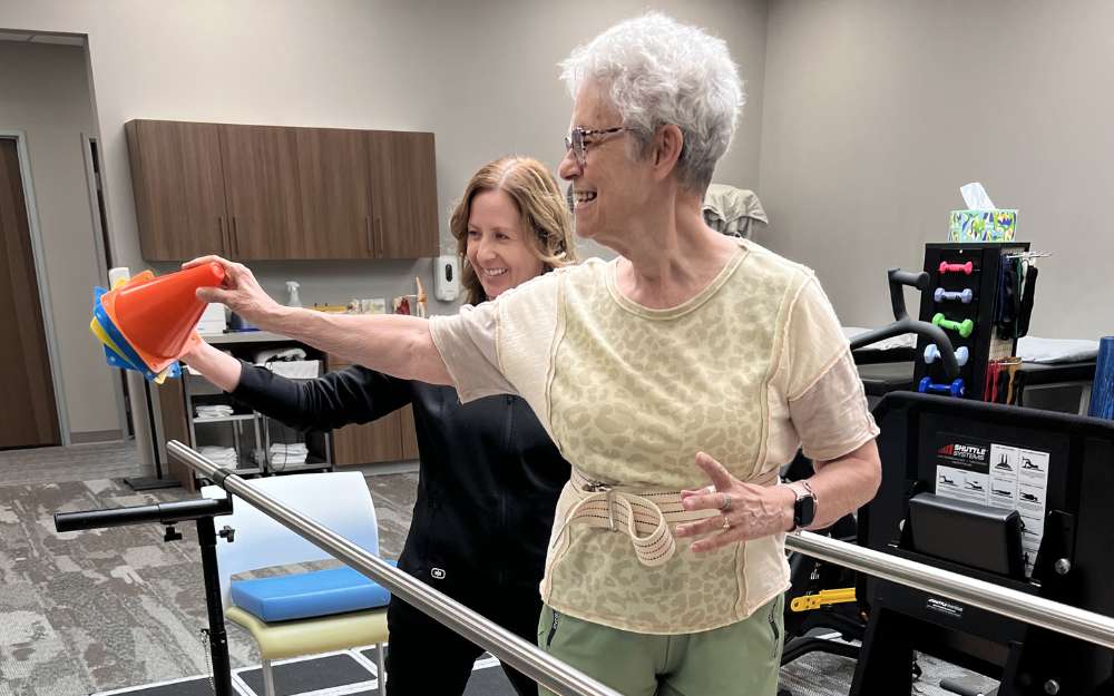physical therapist helping patient with balance